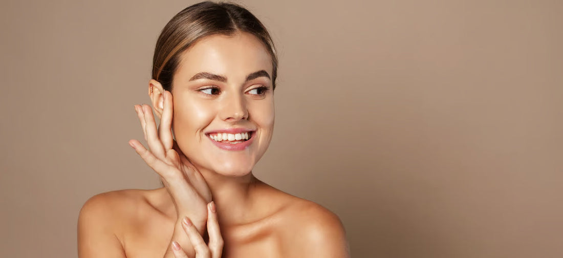 Smiling young woman admiring her glass skin effect after Primabiotic collagen supplementation