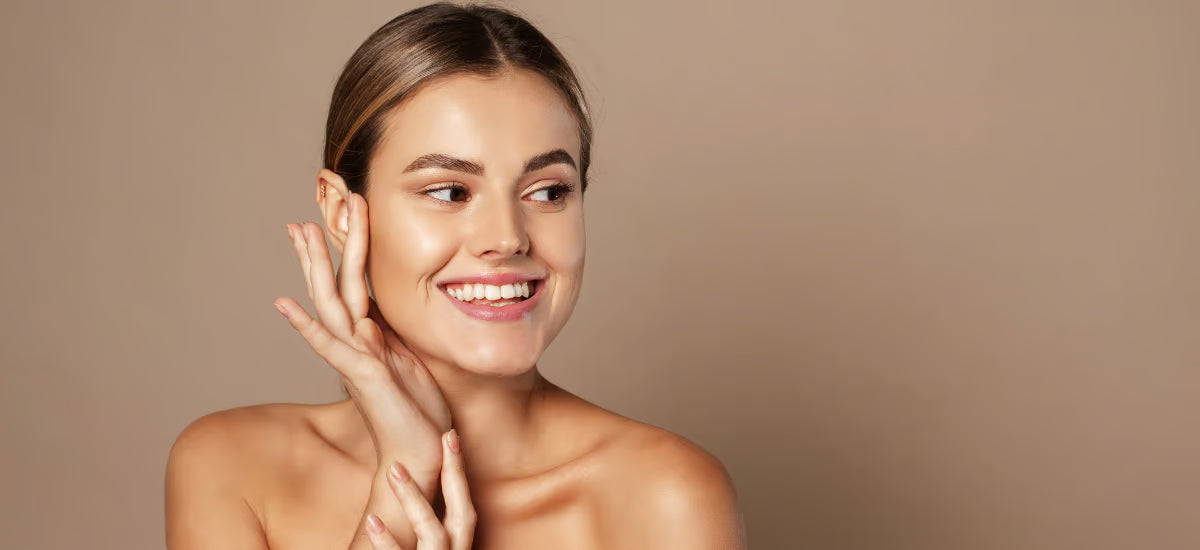 Smiling young woman admiring her glass skin effect after Primabiotic collagen supplementation