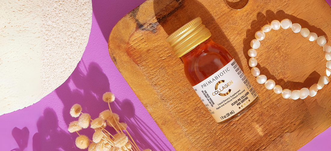 Primabiotic liquid collagen on wooden board with pearl bracelet and dried flowers