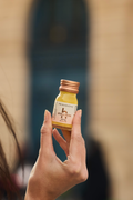 Hand holding a Primabiotic Hyaluron 250mg glass bottle
