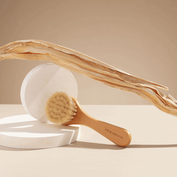 Primabiotic wooden facial massage brush with natural bristles placed